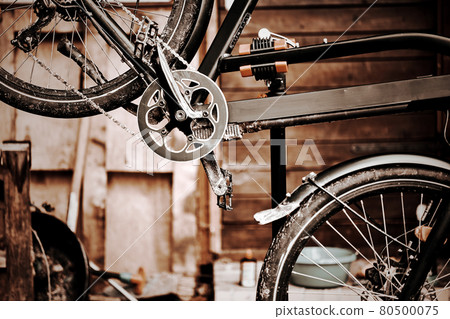 Bicycle on the assembly stand for maintenance and repair, technical abstract image desaturated and with blurred background Bicycle on the assembly stand for maintenance and repair, technical abstract image desaturated and with blurred background 80500075