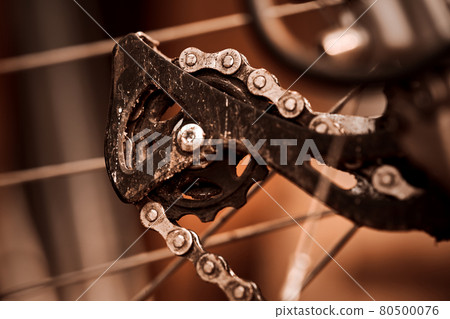 Close-up view of the rear sprocket on the derailleur of a sporty bicycle with gears Close-up view of the rear sprocket on the derailleur of a sporty bicycle with gears 80500076