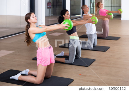 People doing exercises with pilates balls People doing exercises with pilates balls 80500112