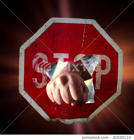 Fist of man punching through red traffic sign with inscription Stop, concept for overcoming, strength, assertiveness Fist of man punching through red traffic sign with inscription Stop, concept for overcoming, strength, assertiveness 80500119