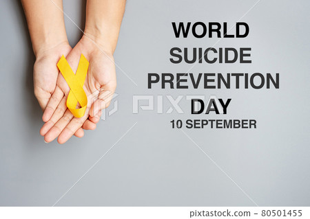World Suicide prevention Day, hand holding Yellow Ribbon for supporting people living and illness World Suicide prevention Day, hand holding Yellow Ribbon for supporting people living and illness 80501455