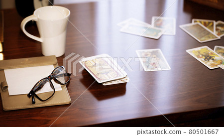 Blurred tarot cards on the table, esoteric concept, fortune telling predictions Blurred tarot cards on the table, esoteric concept, fortune telling predictions 80501667