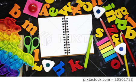 Black blackboard background with coloful letters of the english alphabet. Black blackboard background with coloful letters of the english alphabet. 80501758