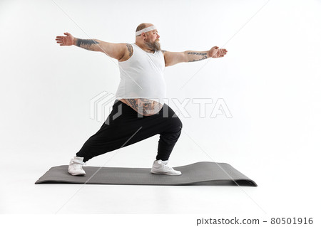 Sporty fat man with beard and tattoos is doing yoga 80501916