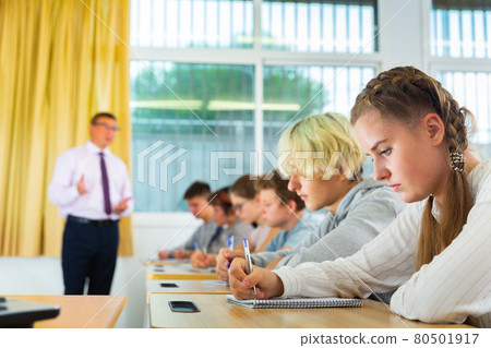 Students listening task for exam in classroom Students listening task for exam in classroom 80501917