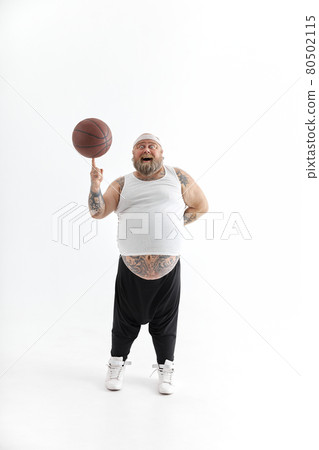 bearded fat caucasian tattoed man with basketball ball in white background. He is funny and happy 80502115