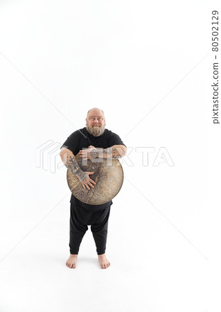 Funn caucasian bearded tattoed man is posing on white background 80502129