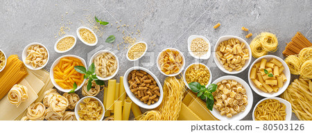 Pasta. Various kinds of uncooked pasta and noodles over stone background, top view with copy space for text. Italian food culinary concept. Collection of different raw pasta on cooking table Pasta. Various kinds of uncooked pasta and noodles over stone background, top view with copy space for text. Italian food culinary concept. Collection of different raw pasta on cooking table 80503126