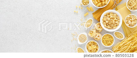 Pasta. Various kinds of uncooked pasta and noodles over stone background, top view with copy space for text. Italian food culinary concept. Collection of different raw pasta on cooking table Pasta. Various kinds of uncooked pasta and noodles over stone background, top view with copy space for text. Italian food culinary concept. Collection of different raw pasta on cooking table 80503128