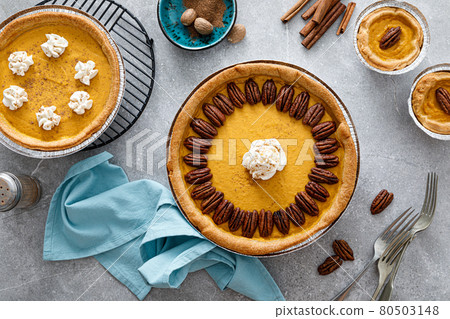 Pumpkin pie with cinnamon, pecan nuts and whipped cream for Thanksgiving, top view. Pumpkin pie with cinnamon, pecan nuts and whipped cream for Thanksgiving, top view. 80503148
