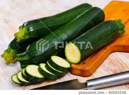 Sliced zucchini on wooden table 80503548
