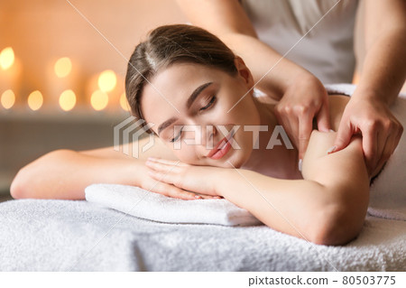 Beautiful woman relaxing and having massage in a SPA. Beautiful woman relaxing and having massage in a SPA. 80503775