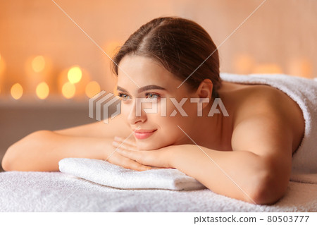 Beautiful woman with honey eyes, in towel relaxing. 80503777