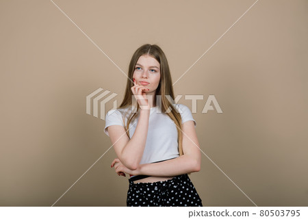 Emotional portrait of surprised woman. Amazement emotion. Studio isolated shooting. 80503795