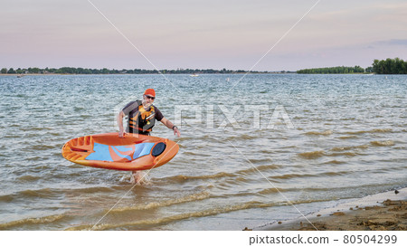 Senior male paddler with a prone kayak 80504299