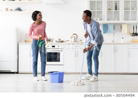 Beautiful black man and woman house-keepers cleaning kitchen Beautiful black man and woman house-keepers cleaning kitchen 80504494