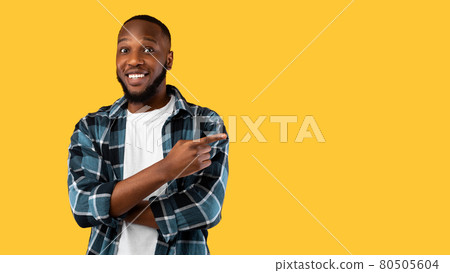 African Guy Pointing Finger Aside Showing Blank Space, Yellow Background 80505604