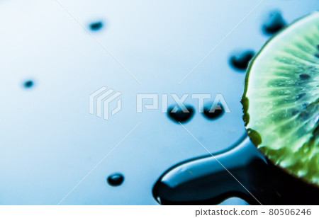 Macro closeup detail of a half slice juicy green fresh tropical kiwi on blue and white background with copy-space Macro closeup detail of a half slice juicy green fresh tropical kiwi on blue and white background with copy-space 80506246
