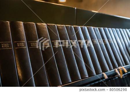 Porvoo, Finland - 2 October 2019: Closeup of a row of green hymn books on finnish language in Porvoo Cathedral. Porvoo, Finland - 2 October 2019: Closeup of a row of green hymn books on finnish language in Porvoo Cathedral. 80506298
