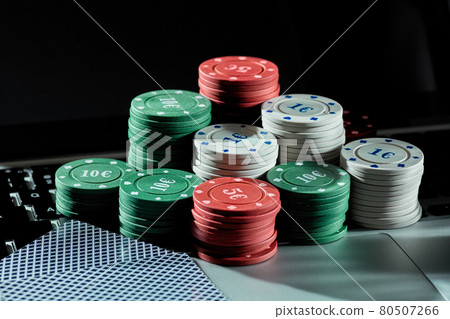 Casino chips and cards on laptop to play gambling online. Casino chips and cards on laptop to play gambling online. 80507266
