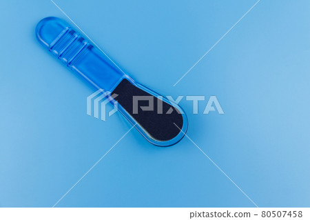 Blue pedicure grater on blue background Blue pedicure grater on blue background 80507458