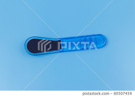 Blue pedicure grater on blue background Blue pedicure grater on blue background 80507459