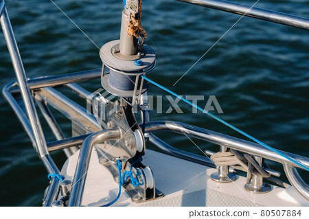 rope on the winch of a white yacht in the sea.yacht equipment rope on the winch of a white yacht in the sea.yacht equipment 80507884