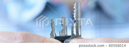 Woman holding many metal keys in her hands closeup 80508014