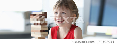 Little girl building tower from wooden blocks Little girl building tower from wooden blocks 80508054