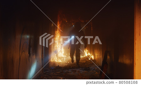 Firefighter searching for survivors in burning building Firefighter searching for survivors in burning building 80508108