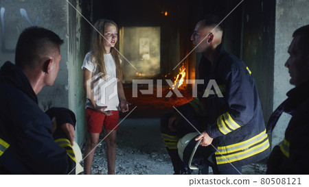 Firemen interrogating saved girl in burning building Firemen interrogating saved girl in burning building 80508121
