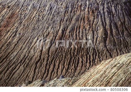 Patterned texture from a dappled hillside moving from wind and moisture with sand and small stone from an abandoned quarry in Armenia Patterned texture from a dappled hillside moving from wind and moisture with sand and small stone from an abandoned quarry in Armenia 80508306