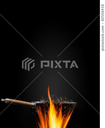 Empty wok pan with smoke above fire against black background. Cooking concept. Mockup, template for your collage, text, images. Advertising. Close up Empty wok pan with smoke above fire against black background. Cooking concept. Mockup, template for your collage, text, images. Advertising. Close up 80508438