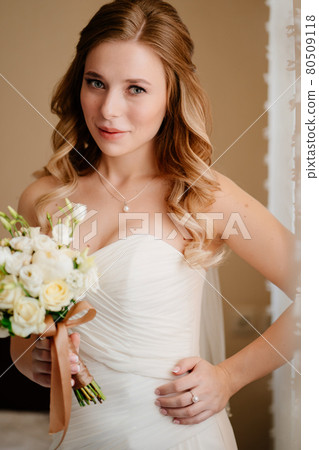 portrait of a beautiful bride with a bouquet. Wedding traditions. portrait of a beautiful bride with a bouquet. Wedding traditions. 80509118