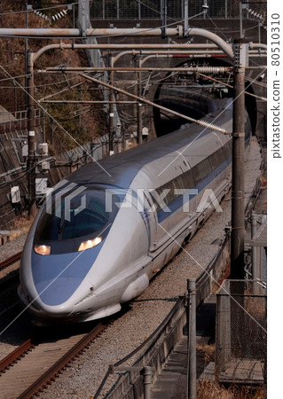 A long train of the 500 series Nozomi bullet train speeding along the Tokaido Shinkansen line. Photo taken on February 24, 2010. A long train of the 500 series Nozomi bullet train speeding along the Tokaido Shinkansen line. Photo taken on February 24, 2010. 80510310