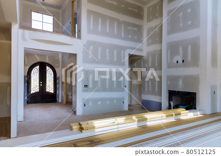 Plastering drywall new home industry on finishing putty in the room walls plasterboards with room under construction 80512125