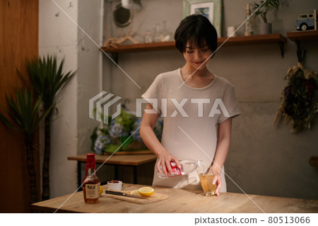 A woman making a highball while cooling on a hot day 6 80513066