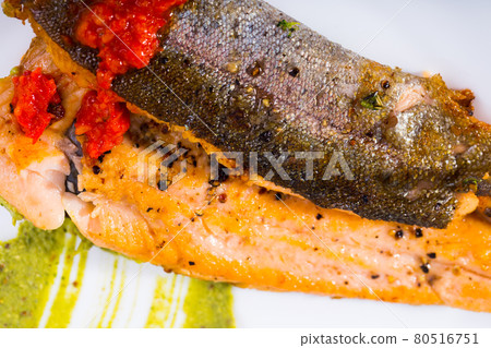 Tasty steak of fried rainbow trout fillet with sauces on plate Tasty steak of fried rainbow trout fillet with sauces on plate 80516751