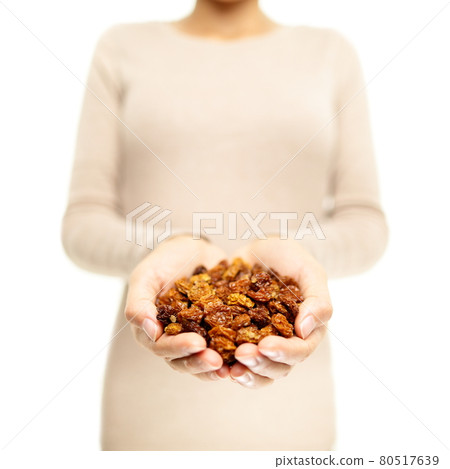 Golden berries. Superfoods - woman showing dried Inca berry, also called ground cherries. Heap of organic healthy golden berry super food. Golden berries. Superfoods - woman showing dried Inca berry, also called ground cherries. Heap of organic healthy golden berry super food. 80517639