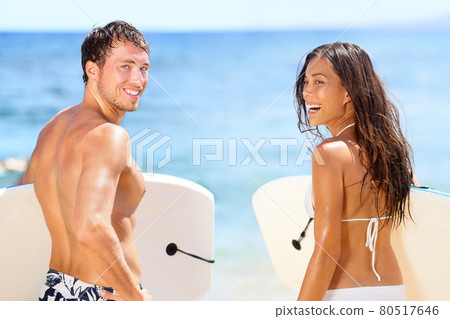 Surfers on beach having fun in summer 80517646