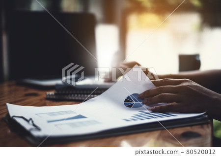 Close-up of a businesswoman using a calculator to audit the company's budget. Tax information is calculated by accountants. Close-up of a businesswoman using a calculator to audit the company's budget. Tax information is calculated by accountants. 80520012