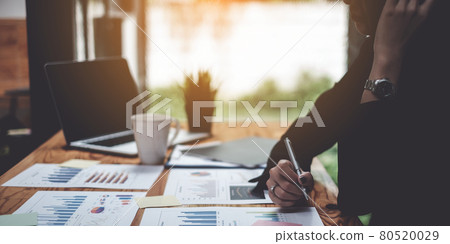 Stressed business woman hard working until morning and tired at table in office while project deadlines. finance, account, tax, audit concept. Stressed business woman hard working until morning and tired at table in office while project deadlines. finance, account, tax, audit concept. 80520029
