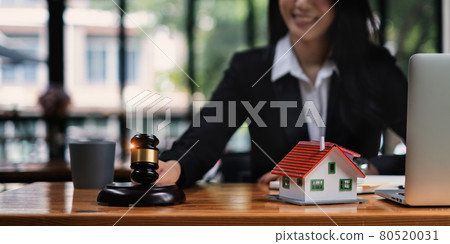Business woman or lawyers discussing contract papers on wooden desk in office. Law, legal services, advice,Judge auction and real estate concept. Business woman or lawyers discussing contract papers on wooden desk in office. Law, legal services, advice,Judge auction and real estate concept. 80520031