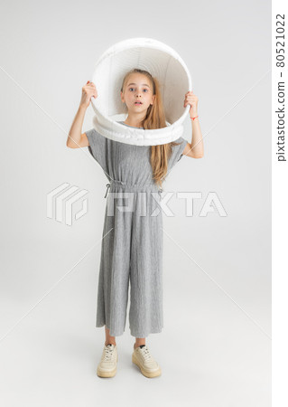 Portrait of little school caucasian girl in large helmet posing isolated over white studio background. Portrait of little school caucasian girl in large helmet posing isolated over white studio background. 80521022
