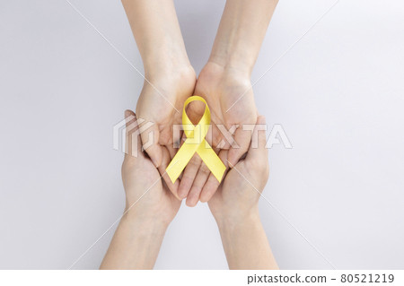 two persons holding yellow ribbon two persons holding yellow ribbon 80521219