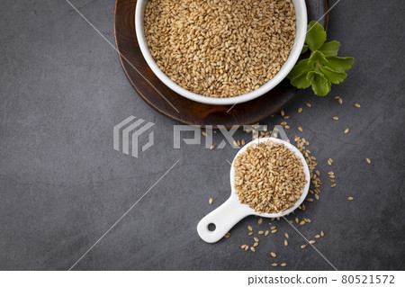 sesame seed in porcelain bowl and spoon sesame seed in porcelain bowl and spoon 80521572