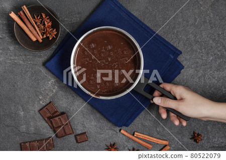 Preparing hot chocolate in a pot top view on grey background. 80522079