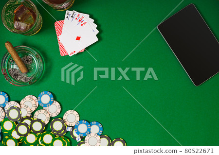 Set to playing poker with cards and chips on green table, top view 80522671