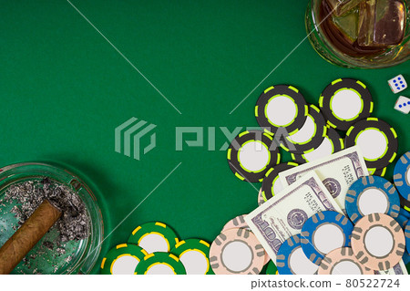 gambling, fortune and entertainment concept - close up of casino chips, whisky glass, playing cards and cigar on green table surface gambling, fortune and entertainment concept - close up of casino chips, whisky glass, playing cards and cigar on green table surface 80522724