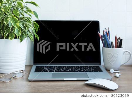 Laptop with office supplies on the table. Laptop with office supplies on the table. 80523029